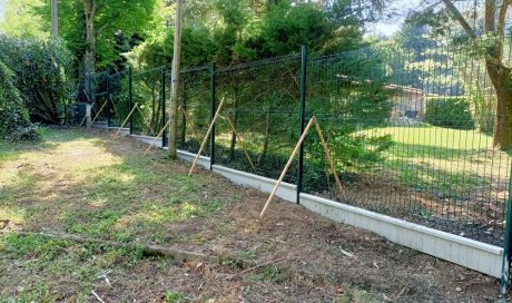 Installation d'une barrière en panneaux rigides avec soubassement béton à ST JEAN DE BOURNAY